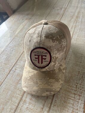 The Frolic and Folk Pub & Grill Camo Mesh Trucker Hat - Tan